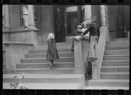 Untitled photo, possibly related to: Children in front of apartment buildings in the better section of the Black Belt, Chicago, Illinois