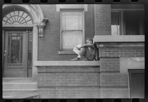 Child in front of apartment building in the better section of the Black Belt, Chicago, Illinois