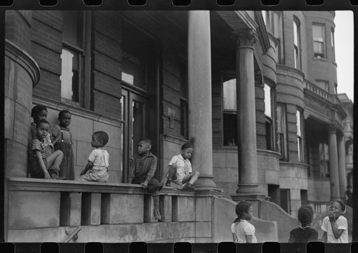 Untitled photo, possibly related to: Children in front of apartment buildings in the better section of the Black Belt, Chicago, Illinois