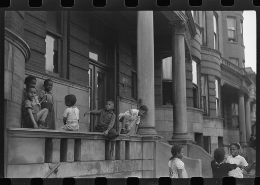 Untitled photo, possibly related to: Children in front of apartment buildings in the better section of the Black Belt, Chicago, Illinois