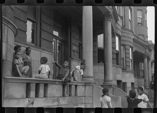 Untitled photo, possibly related to: Children in front of apartment buildings in the better section of the Black Belt, Chicago, Illinois