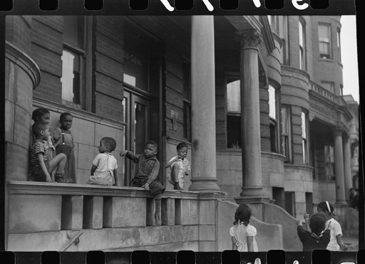 Untitled photo, possibly related to: Children in front of apartment buildings in the better section of the Black Belt, Chicago, Illinois