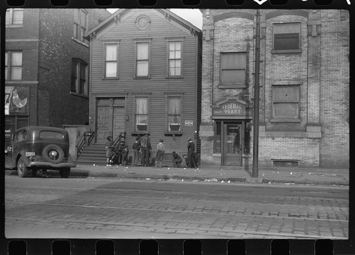 Untitled photo, possibly related to: Street scene. The papers littering the sidewalk are "policy slips." Chicago, Illinois