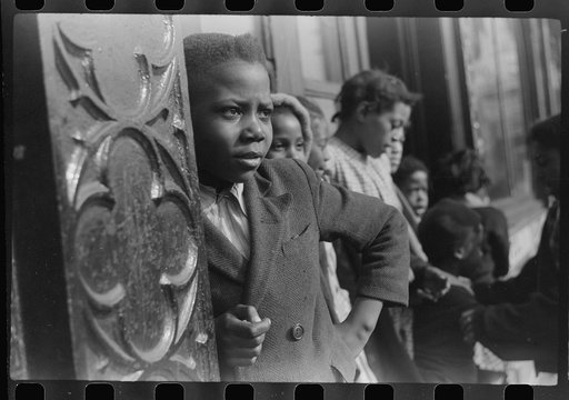 Children in front of "kitchenette" apartment, Black Belt, Chicago, Illinois.