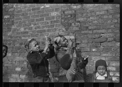 Boys playing that they are shooting machine guns at a passing aeroplane, Black Belt, Chicago, Illinois