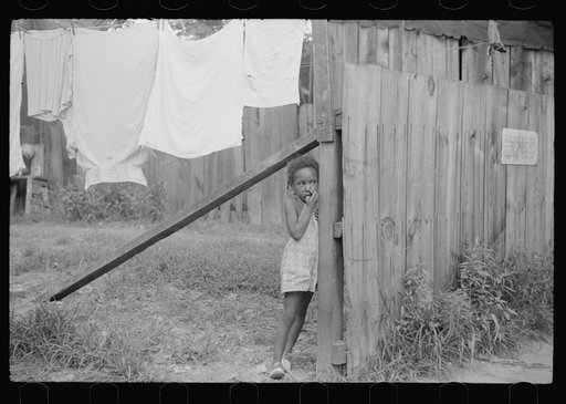 Child and laundry in alley dwelling area, Washington, D.C.