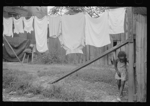 Untitled photo, possibly related to: Child and laundry in alley dwelling area, Washington, D.C.
