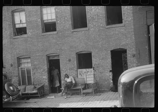 Negroes and their home in the alley dwelling area. Note: building next door is gutted. Washington, D.C.