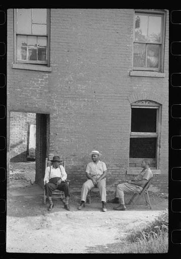 Negroes in front of their homes in the alley dwelling area, Washington, D.C.