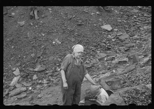 Untitled photo, possibly related to: Woman and child picking coal from a slag heap. They are paid ten cents for each 100 pound sack, Nanty Glo, Pennsylvania
