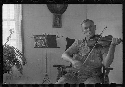 One of the Westmoreland homesteaders playing his violin, Pennsylvania