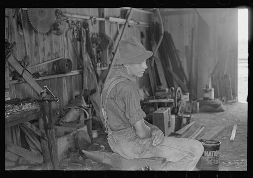 Wheat harvest hand in tool shed, central Ohio