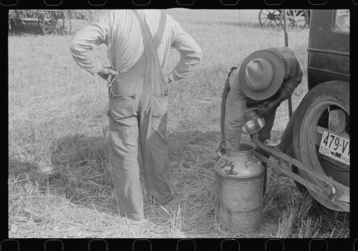 Member of threshing crew getting a drink, central, Ohio