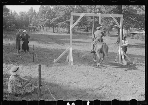 Accokeek, Maryland. A modern version of an old medieval jousting tournament game: picking off a ring on a lance while riding by on horseback at full speed.