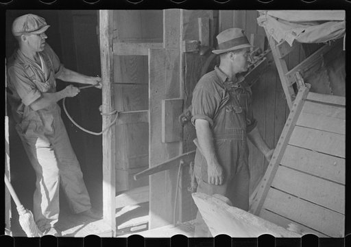 Untitled photo, possibly related to: Unloading truck inside grain elevator, Plain City, Ohio