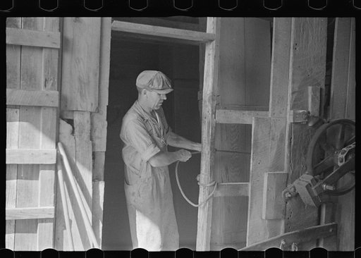 Untitled photo, possibly related to: Unloading truck inside grain elevator, Plain City, Ohio