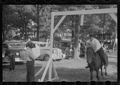Accokeek, Maryland. A modern version of an old medieval jousting tournament game: picking off a ring on a lance while riding by on horseback at full speed.