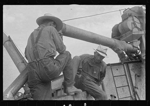 Untitled photo, possibly related to: Two members of threshing crew, central Ohio (see general caption)