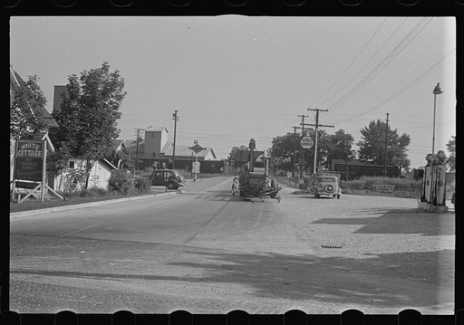 Untitled photo, possibly related to: Cars parked beside feed store, Plain City, Ohio