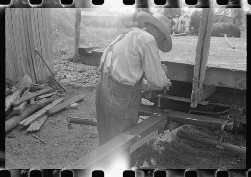 Farmer repairing wagon, central Ohio