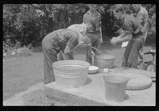 Untitled photo, possibly related to: Washing up before dinner during wheat harvest, Central Ohio
