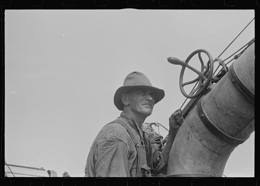 Untitled photo, possibly related to: Adjusting straw stacker or grain separator, Ohio