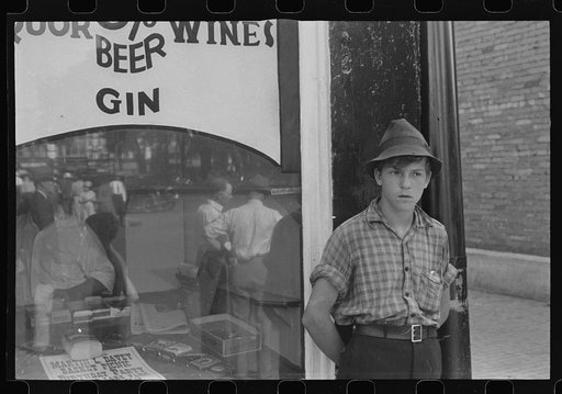Boy in front of liquor store, Newark, Ohio