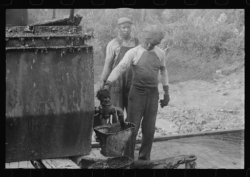 Workers repairing Route 40, central Ohio. Vat for heating tar used in repairing brick road on Route 40