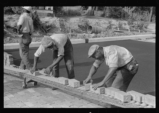 Special laborsaving rollers used in moving brick for road repair, Route 40, central Ohio