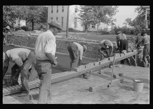 Special laborsaving rollers used in moving brick for road repair, Route 40, central Ohio