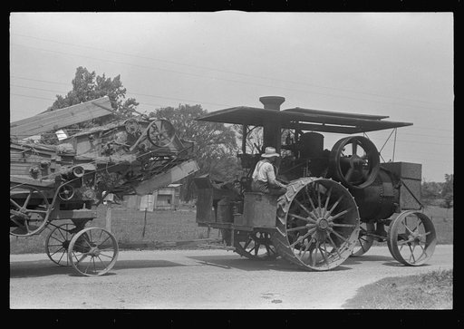 Steam tractor pulling grain separator along country road, central Ohio