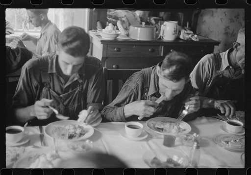 Threshing hands eating dinner, wheat harvest time, central Ohio