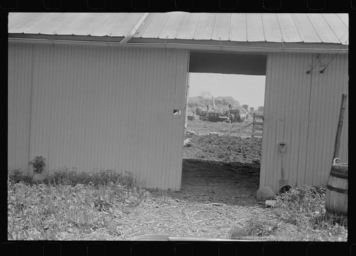 Threshing seen through barn doors, central Ohio