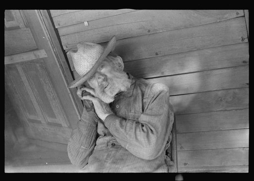 Untitled photo, possibly related to: Circleville, Ohio's "Hooverville" (see general caption). Begins to talk: "No man in the United States had the trouble I had since 1931. No man. Don't talk to me. I'm deaf. I lost my farm in 1931. I went to work in an acid factory. I got acid spilt on me; burnt my