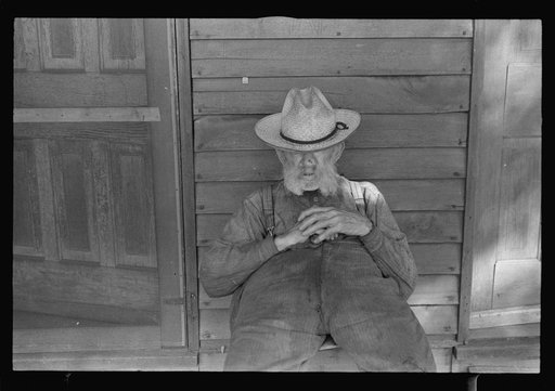 Untitled photo, possibly related to: Circleville, Ohio's "Hooverville" (see general caption). Begins to talk: "No man in the United States had the trouble I had since 1931. No man. Don't talk to me. I'm deaf. I lost my farm in 1931. I went to work in an acid factory. I got acid spilt on me; burnt my