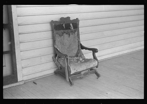 Dilapidated chair on porch at farmland auction, New Carlisle [i.e. Marysville], Ohio