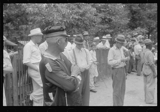 Spectators and clocker at county fair in central Ohio