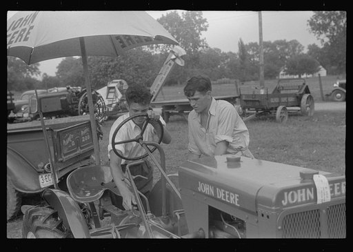 Examining tractor on display at county fair, central Ohio