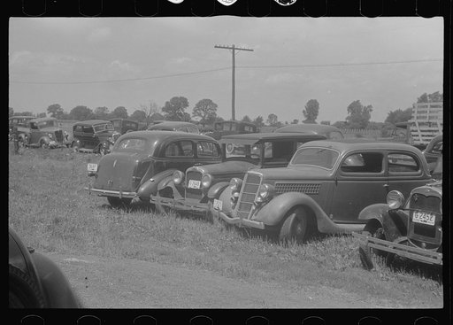 Farmers' cars parked outside of public auction, central Ohio