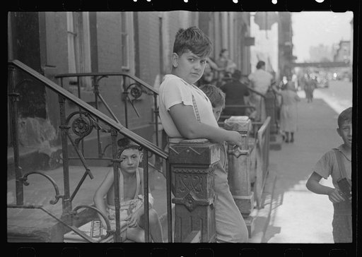 New York, New York. 61st Street between 1st and 3rd Avenues. Children playing in the street