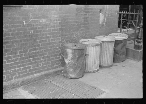New York, New York. 61st Street between 1st and 3rd Avenues. Garbage cans
