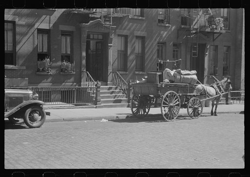 New York, New York. 61st Street between 1st and 3rd Avenues. A tenant is moving on horse-drawn wagon