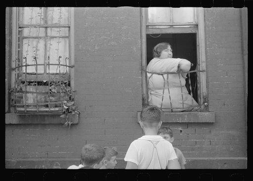 New York, New York. 61st Street between 1st and 3rd Avenues. Children playing in the street