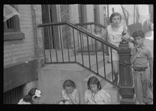 New York, New York. 61st Street between 1st and 3rd Avenues. Children playing in the street