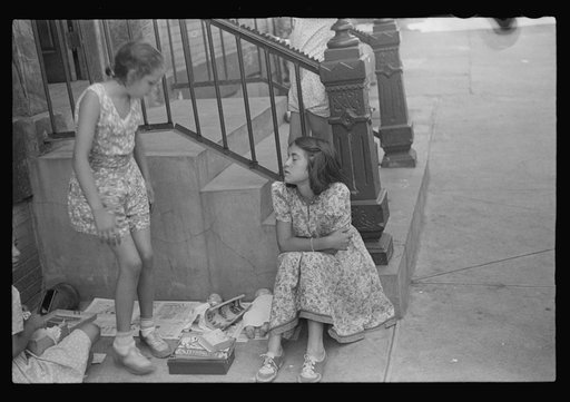New York, New York. 61st Street between 1st and 3rd Avenues. Children playing in the street