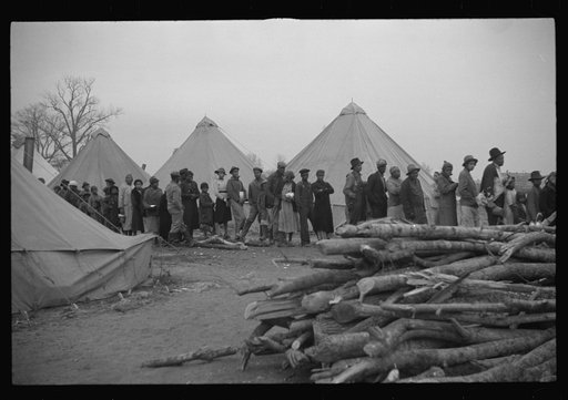 Untitled photo, possibly related to: Negroes in the lineup for food at meal time in the camp for flood refugees, Forrest City, Arkansas