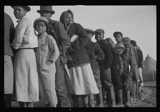 Untitled photo, possibly related to: Negroes in the lineup for food at the flood refugee camp, Forrest City, Arkansas