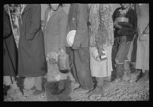 Untitled photo, possibly related to: Negroes at mealtime in the flood refugee camp, Forrest City, Arkansas