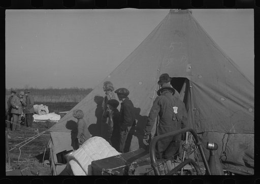 Untitled photo, possibly related to: Setting up a tent in the camp for white flood refugees, Forrest City, Arkansas