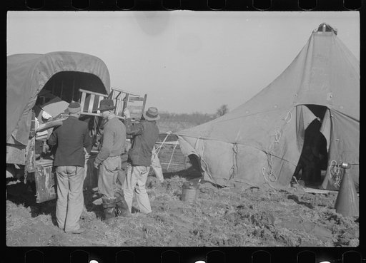 Untitled photo, possibly related to: Unloading the household goods of a family who is being moved into the camp for white flood refugees at Forrest City, Arkansas